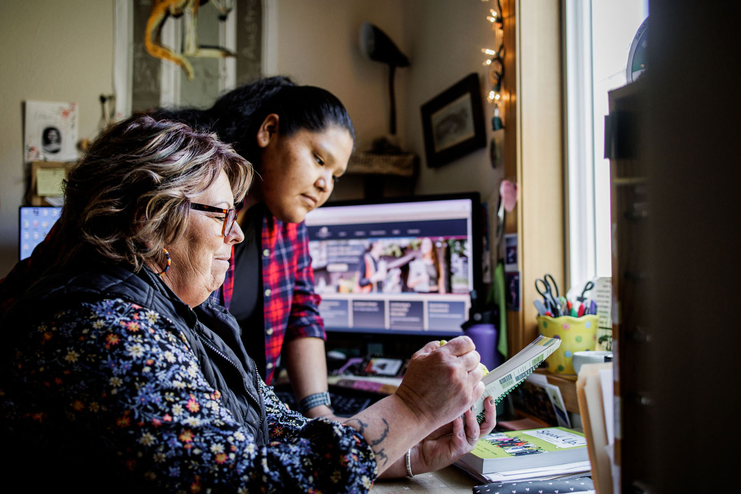 A student and teacher discussing work.