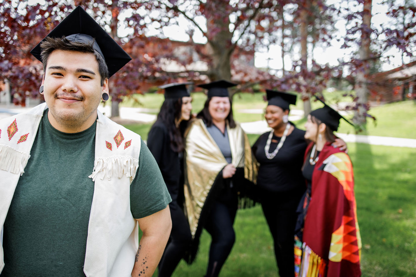 A group of students posing for a graduation photo.