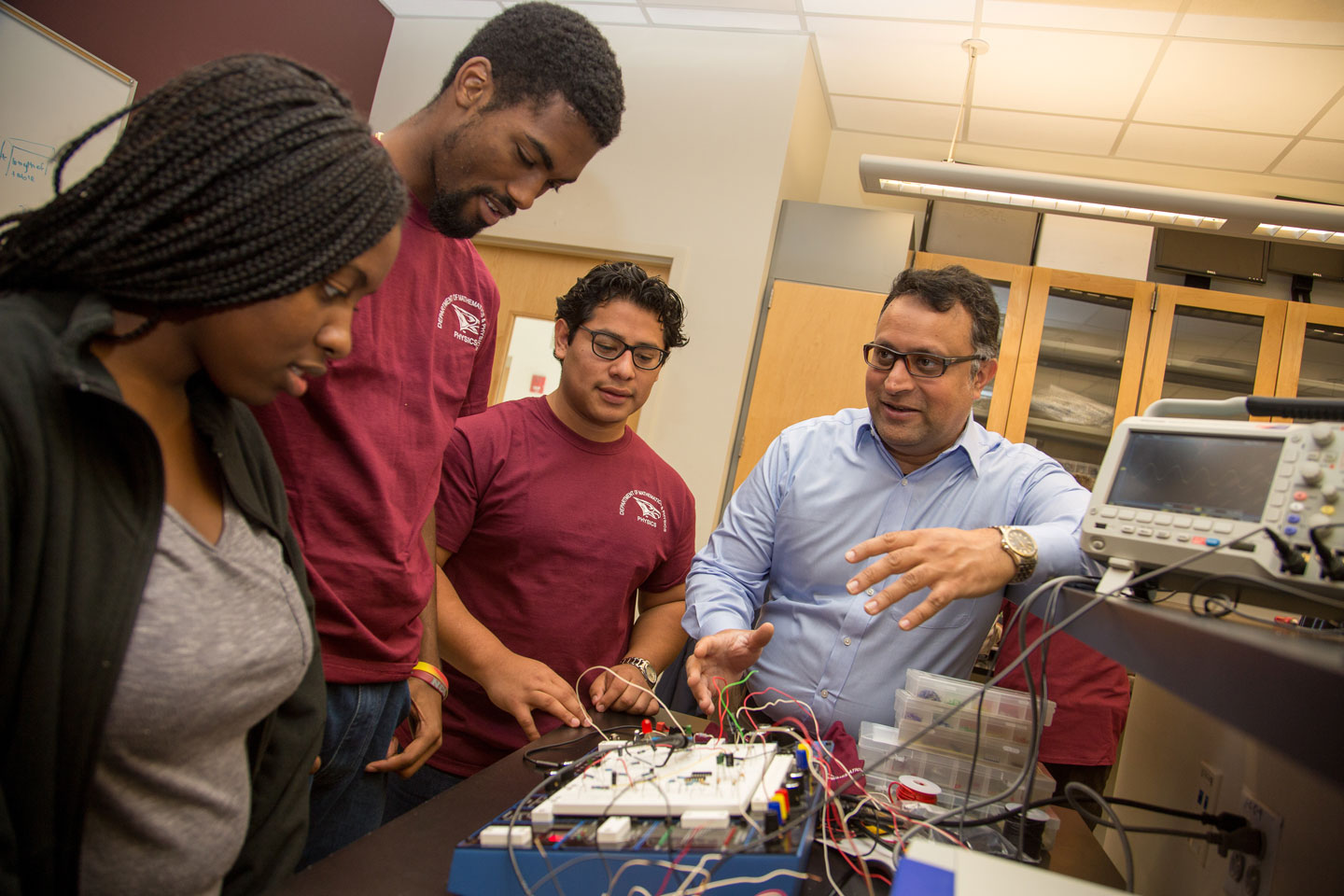 A group of students in a classroom learning from a professor.