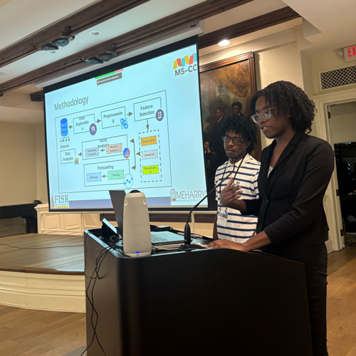 Two students presenting from a podium at an event.