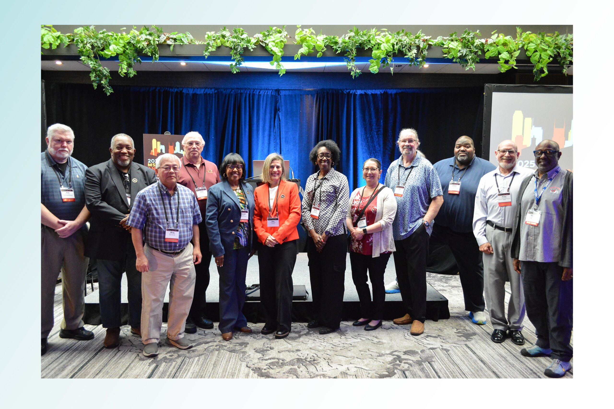 MS-CC Governance Board members pose for a group photo in front of a stage at the 2025 MS-CC Annual Meeting.